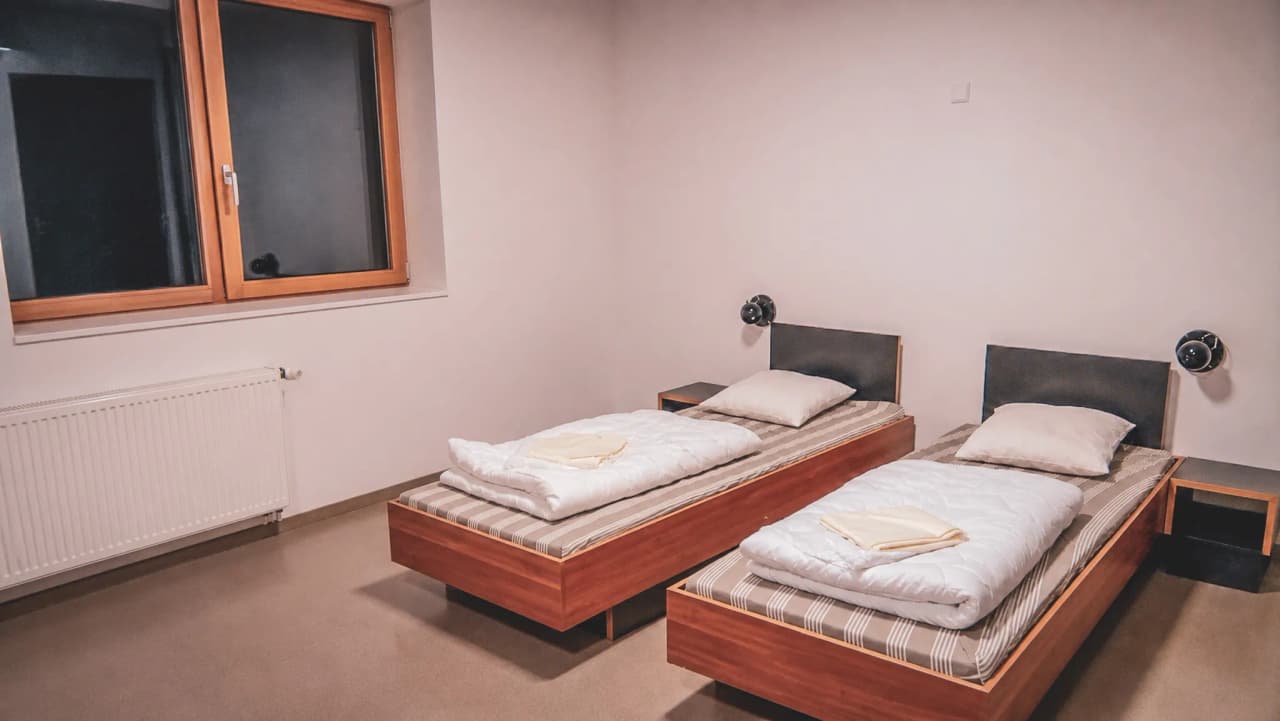A simple, modern room with comfortable beds, ideal for relaxing after a nature adventure.