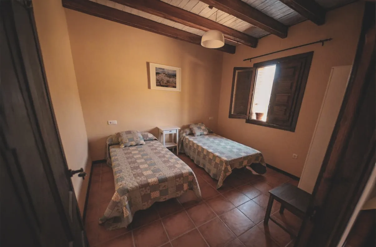 Cosy room with two beds, perfect for resting after an adventure in the Sierra de Guara.