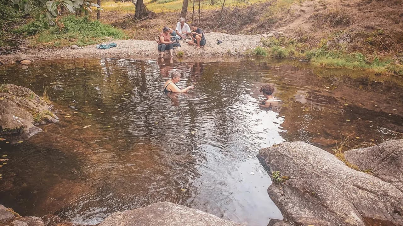 Group bathing in tranquil waters, surrounded by nature in the Cévennes.