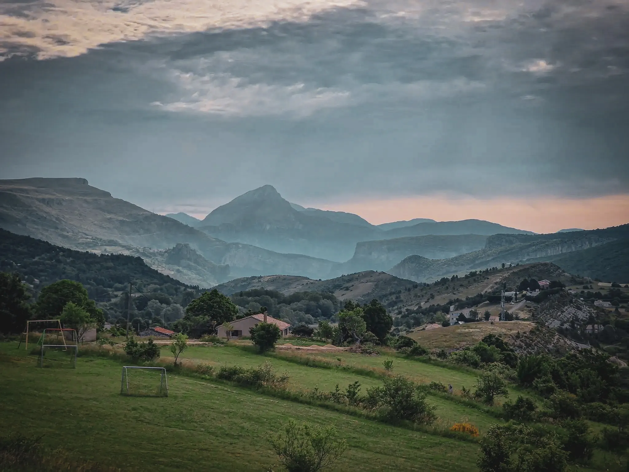 Magnificent scenery of the Gorges du Verdon, majestic mountains under a cloudy sky.