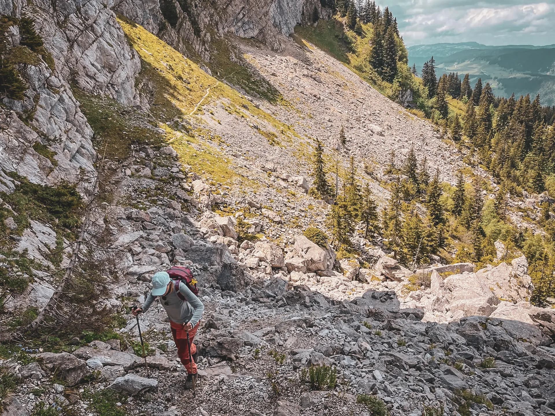 Hikere in the mountains on a rocky path, surrounded by the wild beauty of the Aravis mountains.