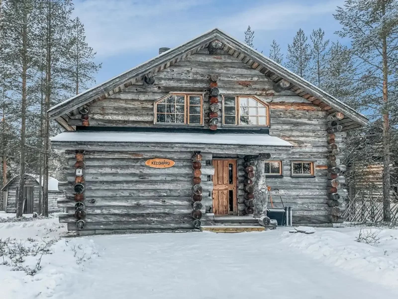 Charmante cabane en bois entourée de neige et de forêts en Laponie, invitation au voyage.