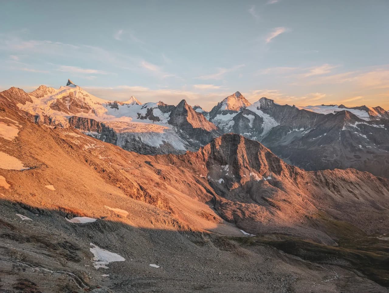 Spectacular views of the Swiss Alps at sunset, with snow-capped peaks and majestic landscapes.