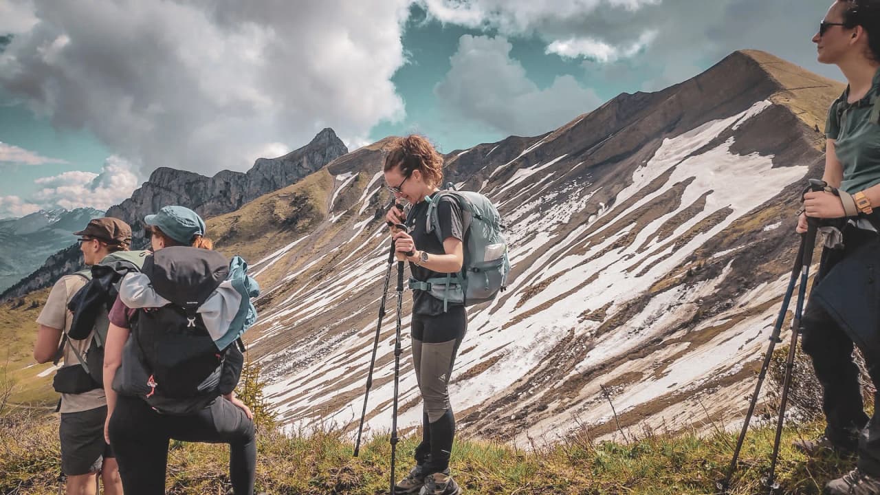 A group of hikers admiring the majestic peaks of the Hautes Bauges in a natural setting.