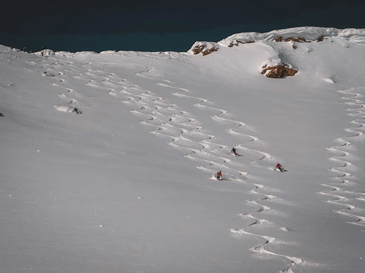 Skiers making furrows in the immaculate snow of the Lyngen Alps, Norway. A unique adventure!