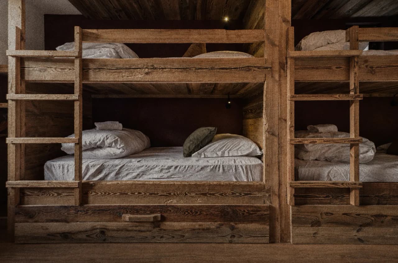 Cosy wooden bunk beds, perfect for a warm and welcoming stay in the mountains after a day of adventure.