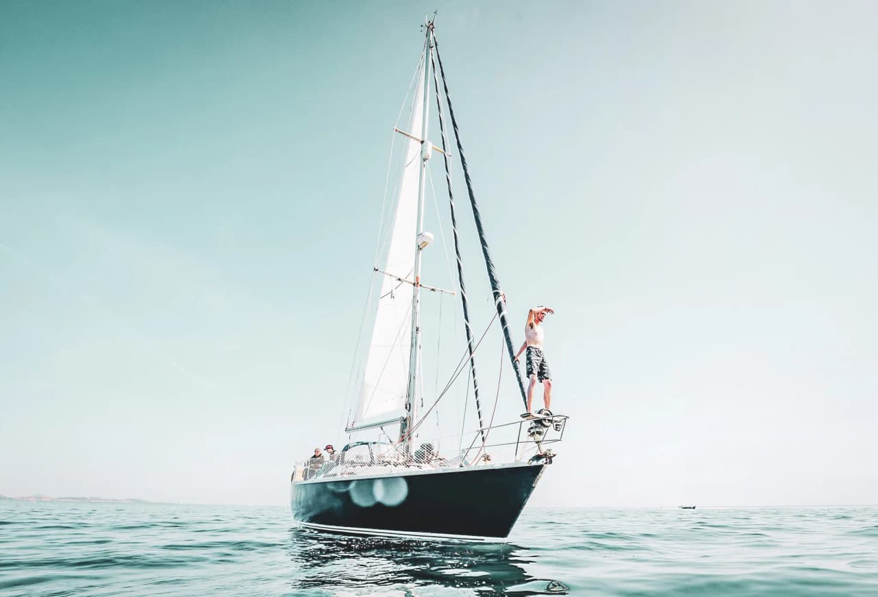 Sailing peacefully on turquoise waters, clear skies ideal for adventure at sea.