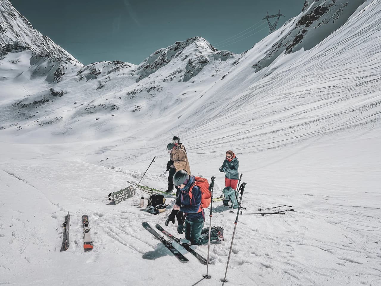 A group of skiers preparing for an adventure in a spectacular snow-covered alpine landscape.