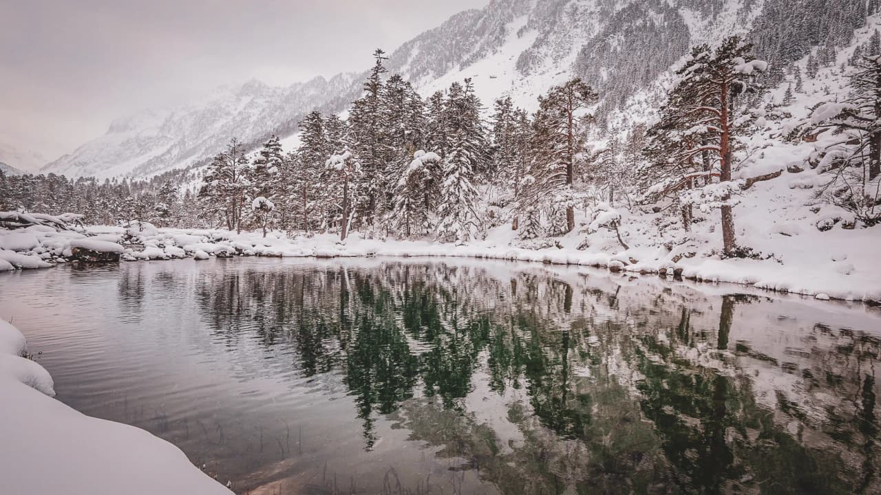 A magical mountain landscape: frozen ponds, snow-covered forests and majestic peaks.