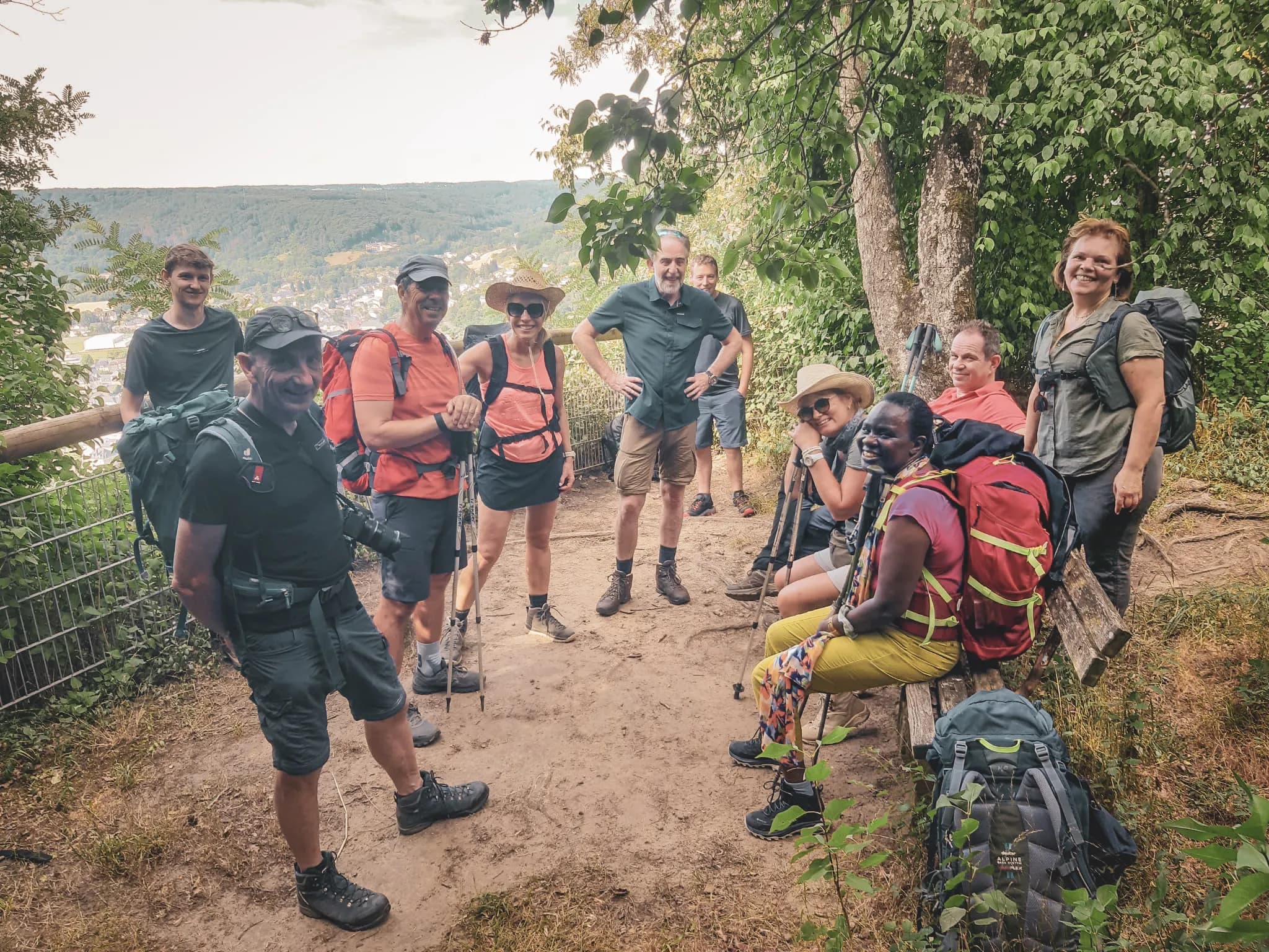 A group of smiling hikers take a break in Luxembourg's verdant Little Switzerland.
