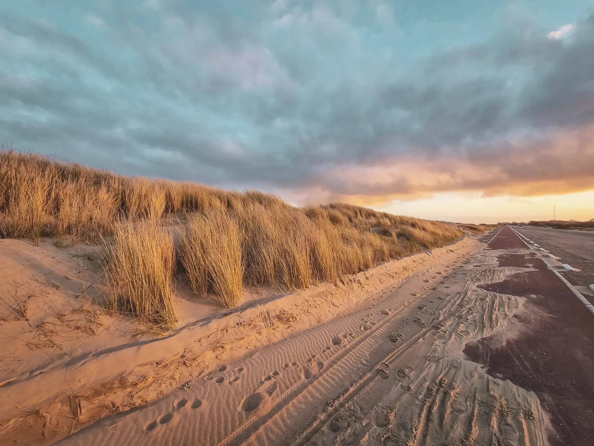 Golden dune at sunset, quiet coastal path invites you to adventure in Zeeland.