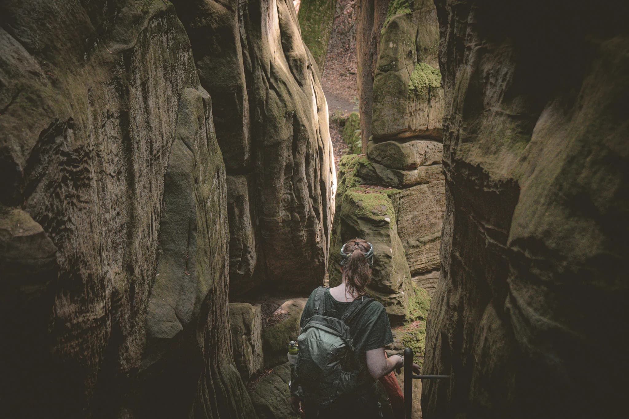 A hiker explores the mysterious cliffs of Luxembourg's Little Switzerland.