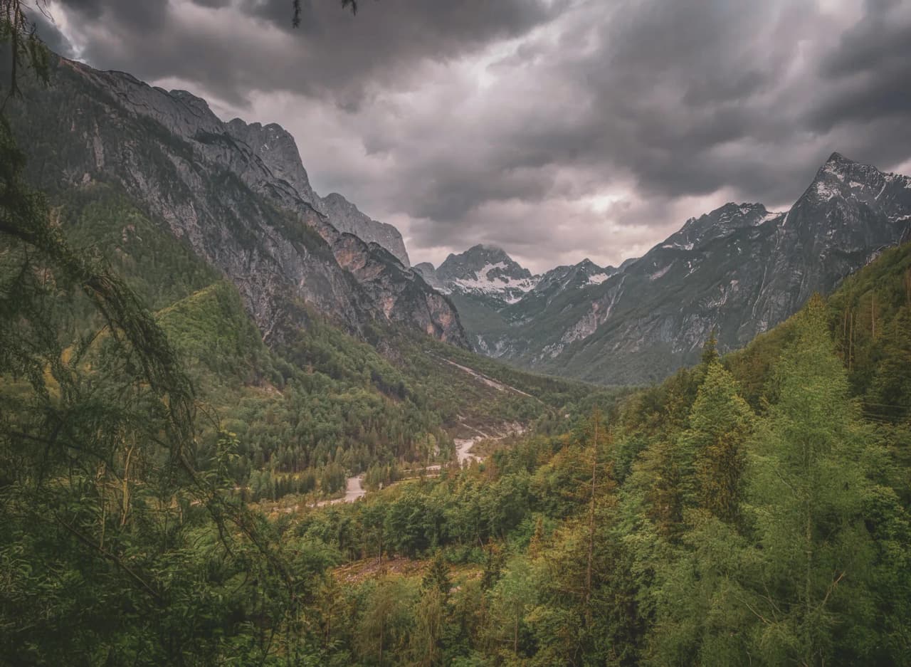 Green alpine valley under a cloudy sky, Slovenia's majestic landscapes.