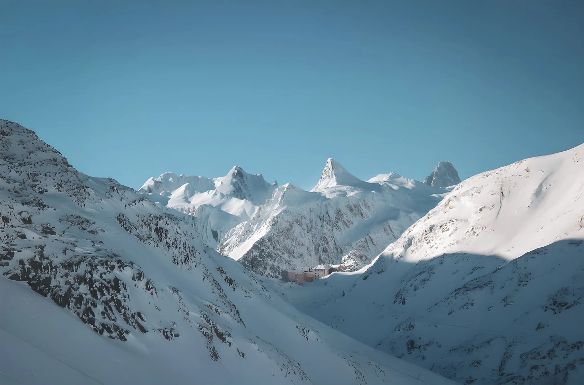 A serene panorama of the snow-capped mountains around the Great Saint Bernard Pass, an invitation to adventure.