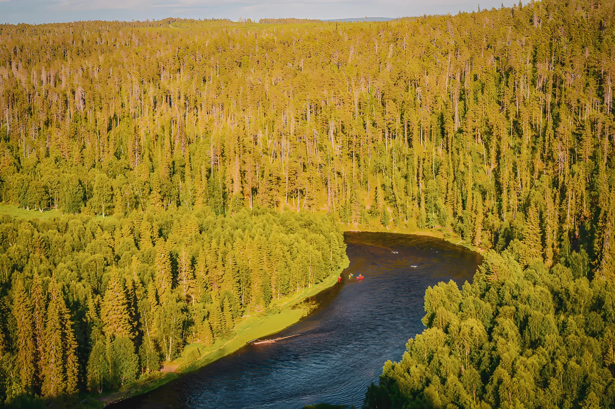 Waterfalls and lush forests on the wild rivers of Oulanka, packraft adventure.
