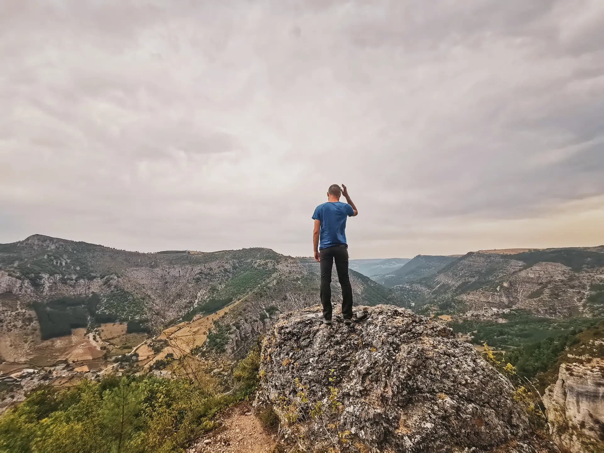 Un randonneur contemplant les paysages époustouflants des Gorges du Tarn, invitations à l'aventure.