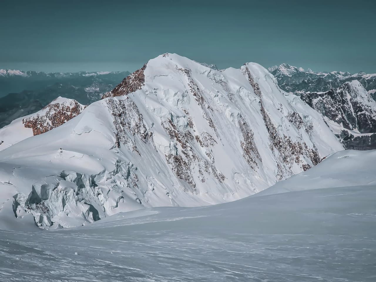 The snow-capped mountains of Mont Rose, with sparkling glaciers under a serene sky. Alpine adventure!