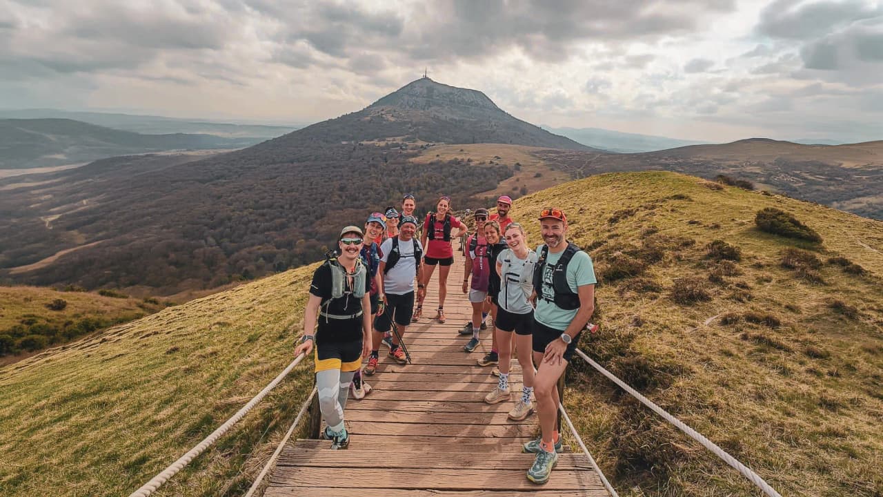A group of hikers in the heart of nature, with the Auvergne volcanoes as a backdrop.