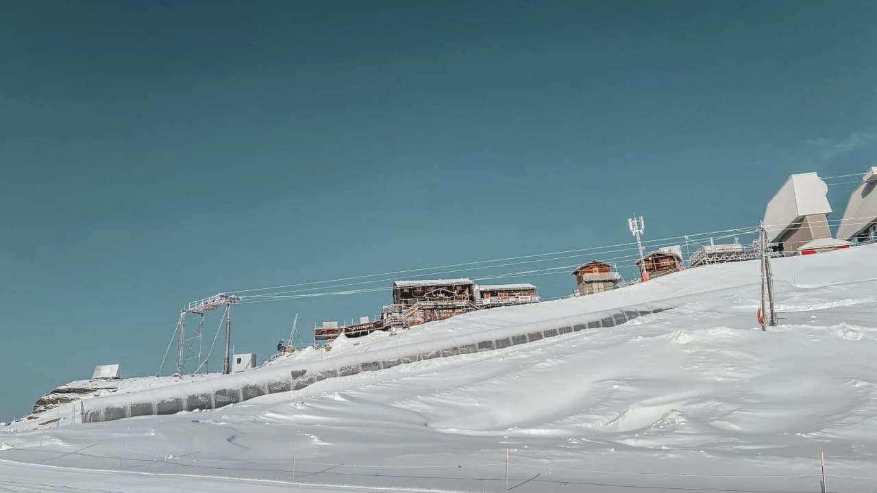 Panoramic views of an alpine ski area, with immaculate snow and welcoming Mountain huts.