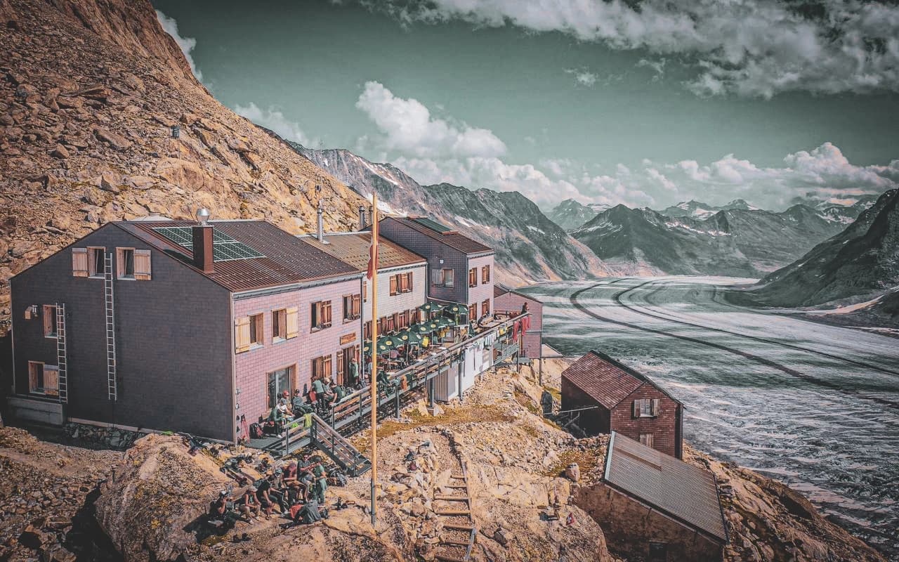 Alpine Mountain hut overlooking the Aletsch glacier, with a warm atmosphere and majestic panoramas.