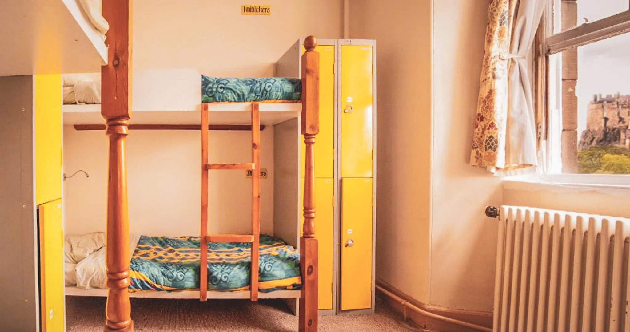 Cosy room with bunk beds and lockers, ideal for relaxing after an adventure.