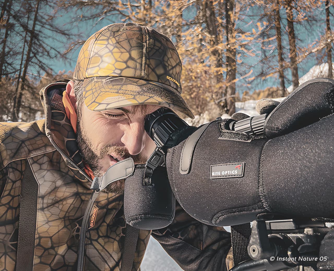 An observer scanning the majestic fauna of the Écrins, dressed in camouflage, ready for adventure.