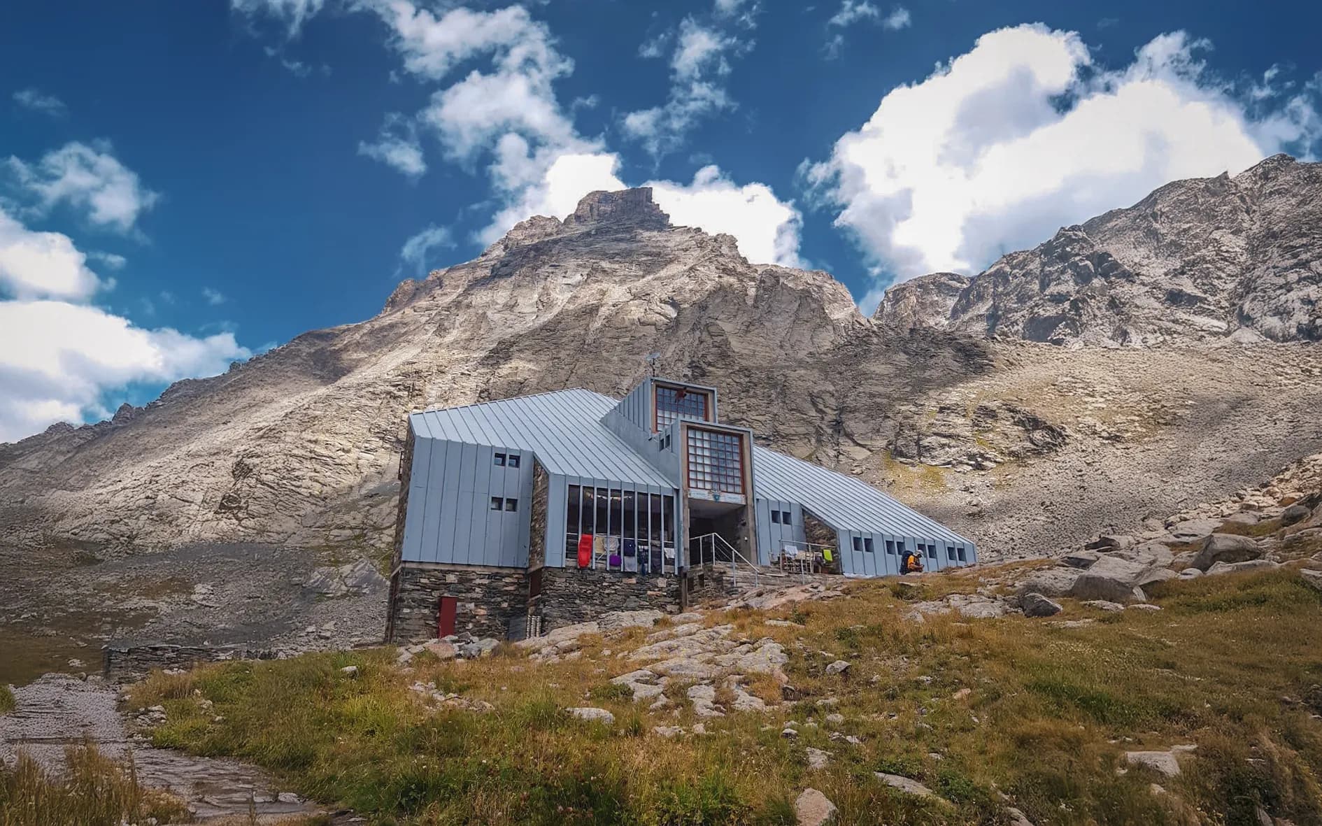 A modern Mountain hut at the foot of majestic mountains, perfect for an unforgettable alpine adventure.
