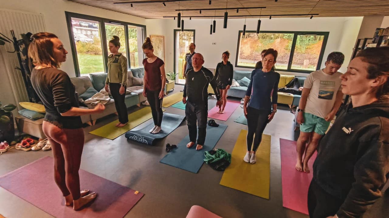 A group of athletes in a yoga session, ready to explore the volcanoes of the Auvergne.