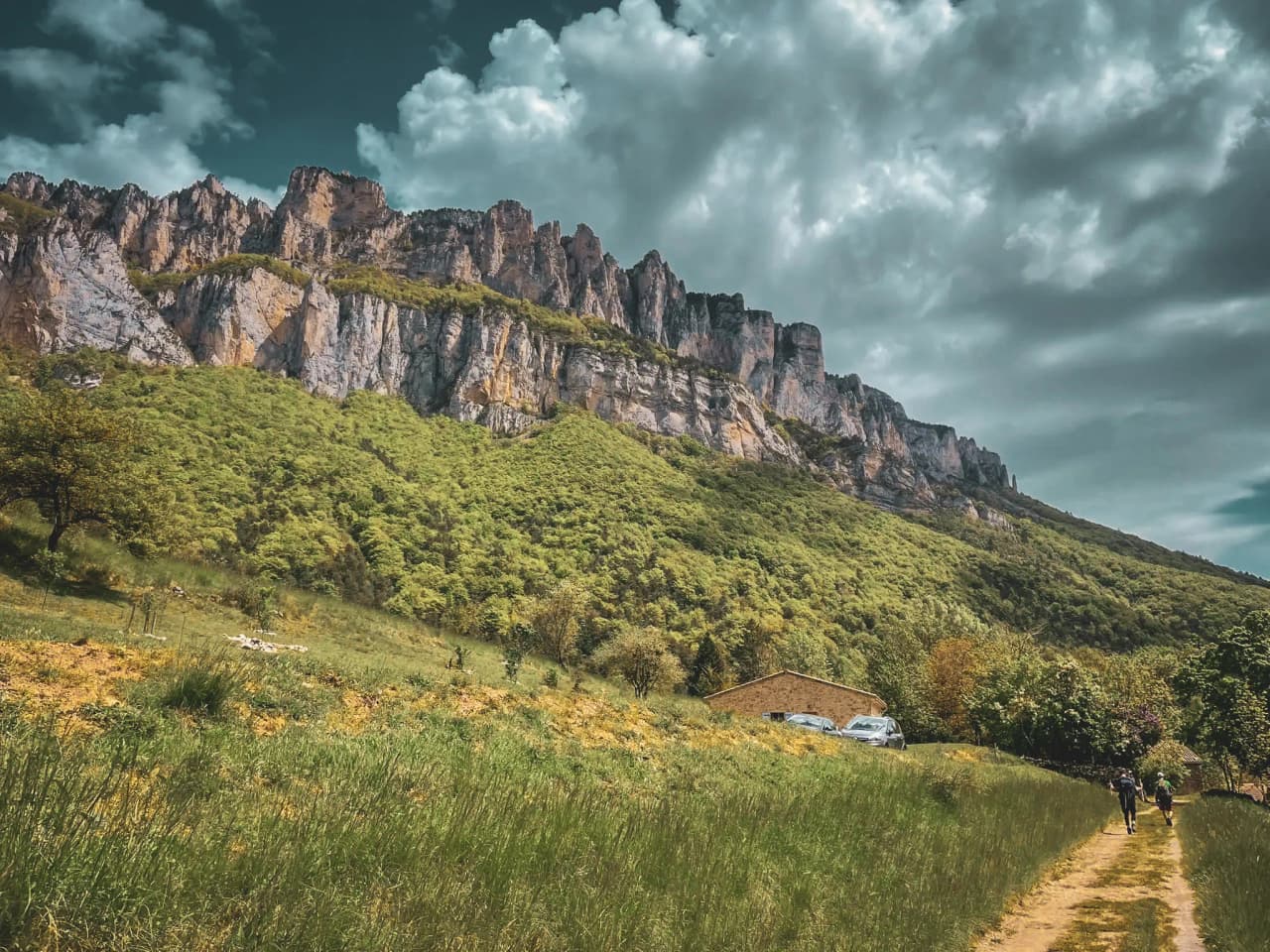 The majestic scenery of Mont Aiguille, with its impressive cliffs and lush greenery.