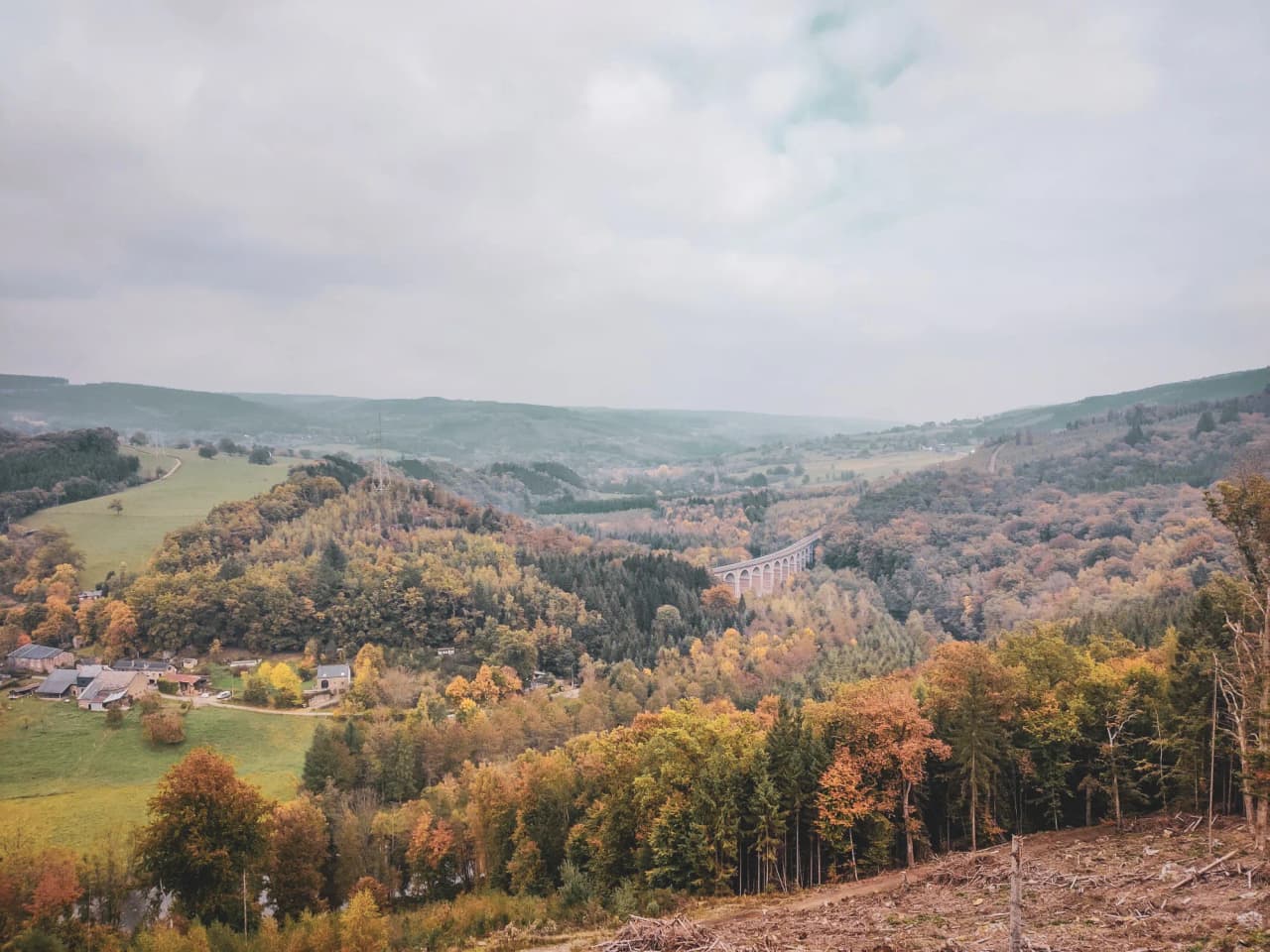 The autumn landscape of the Ardennes, lush green valleys, majestic bridges and colourful forests.