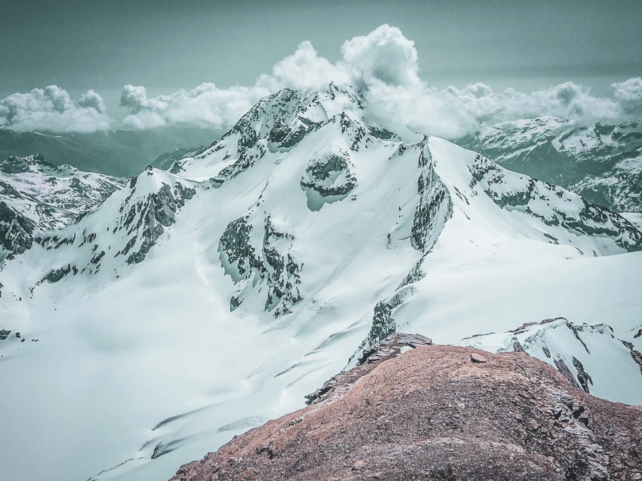 Majestic Vanoise glaciers, between snow-capped peaks and majestic clouds.