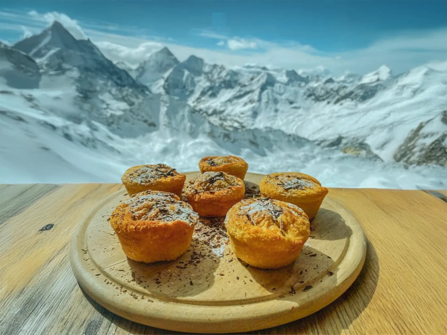 Enjoy muffins while gazing at the majestic snow-covered Swiss Alps.
