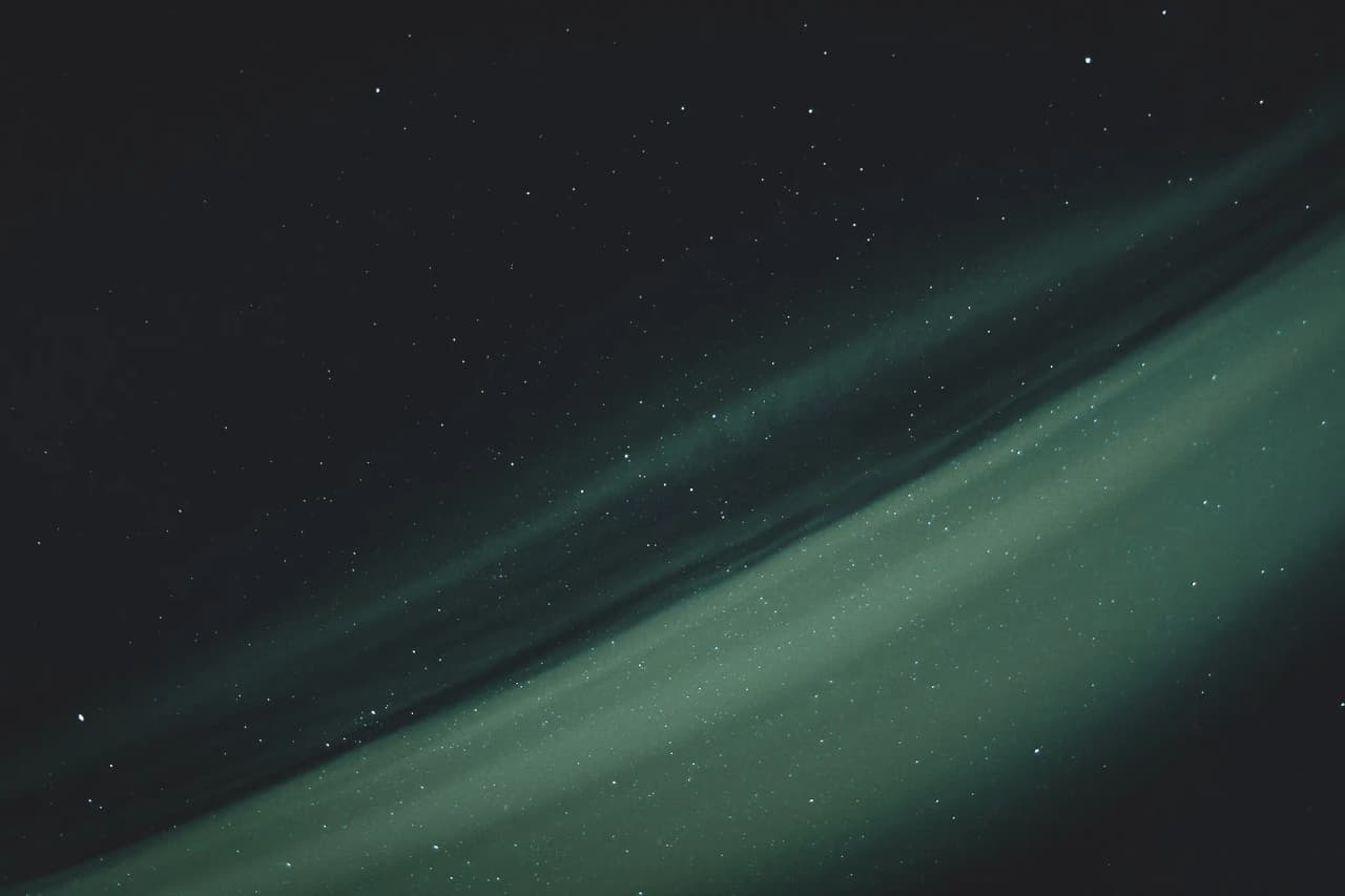 Luminous starry sky with bands of green light, reminiscent of the northern lights in Lapland.