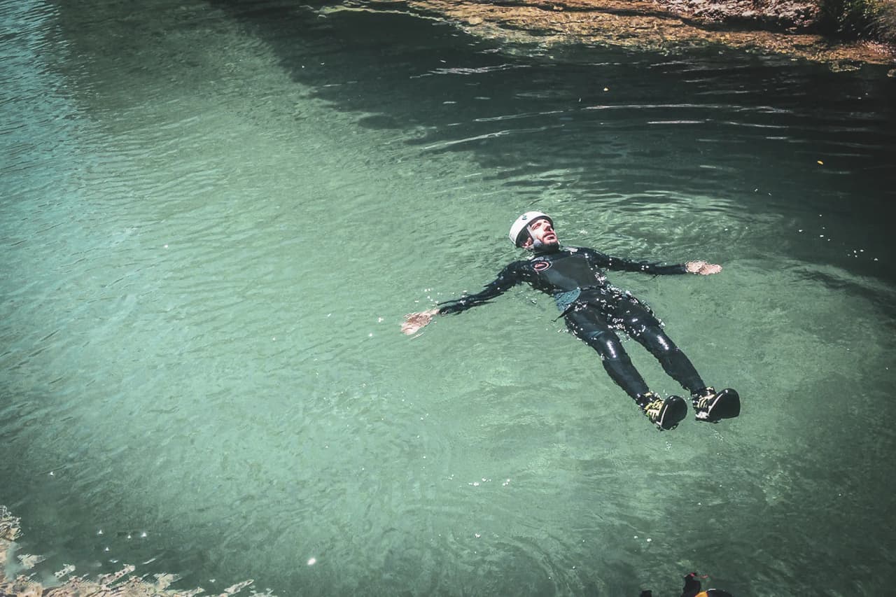 An adventurer floating serenely in crystal-clear waters in the Sierra de Guara.