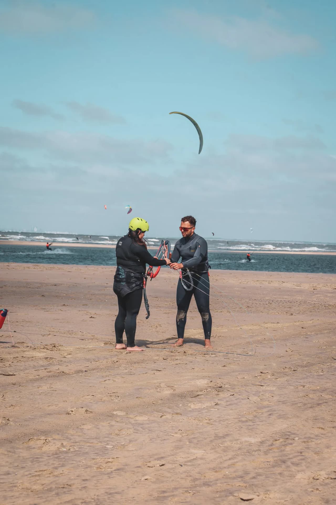 People in grey sailor suits on a beach