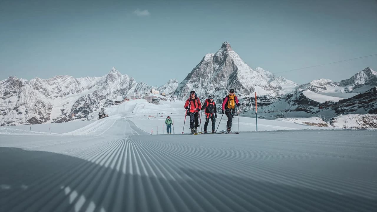 Skiers make their way down the snow-covered slopes of the majestic 4000 metre Mont Rose.