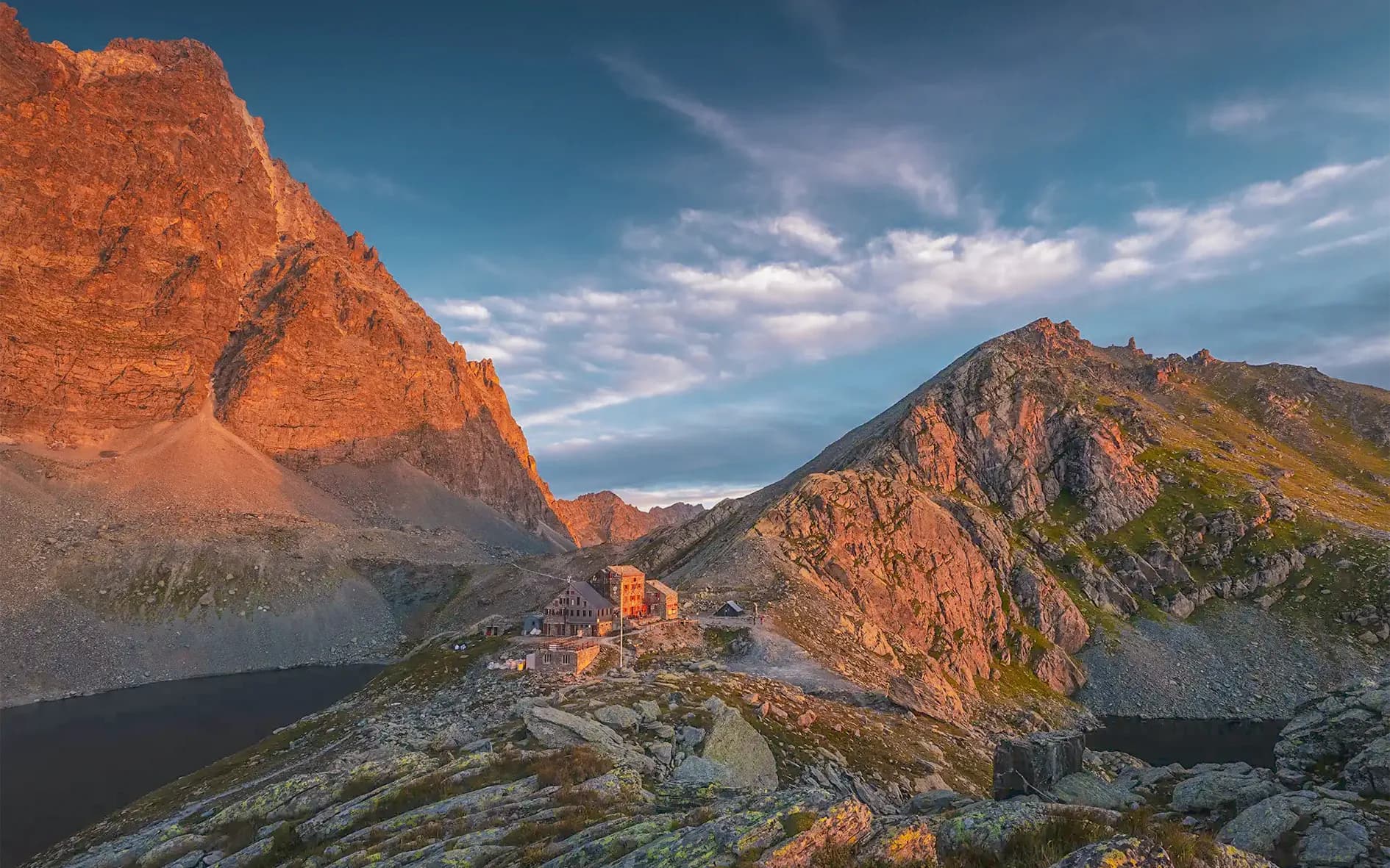 Hikers discover a picturesque Mountain hut at the foot of the majestic Golden Mountains.