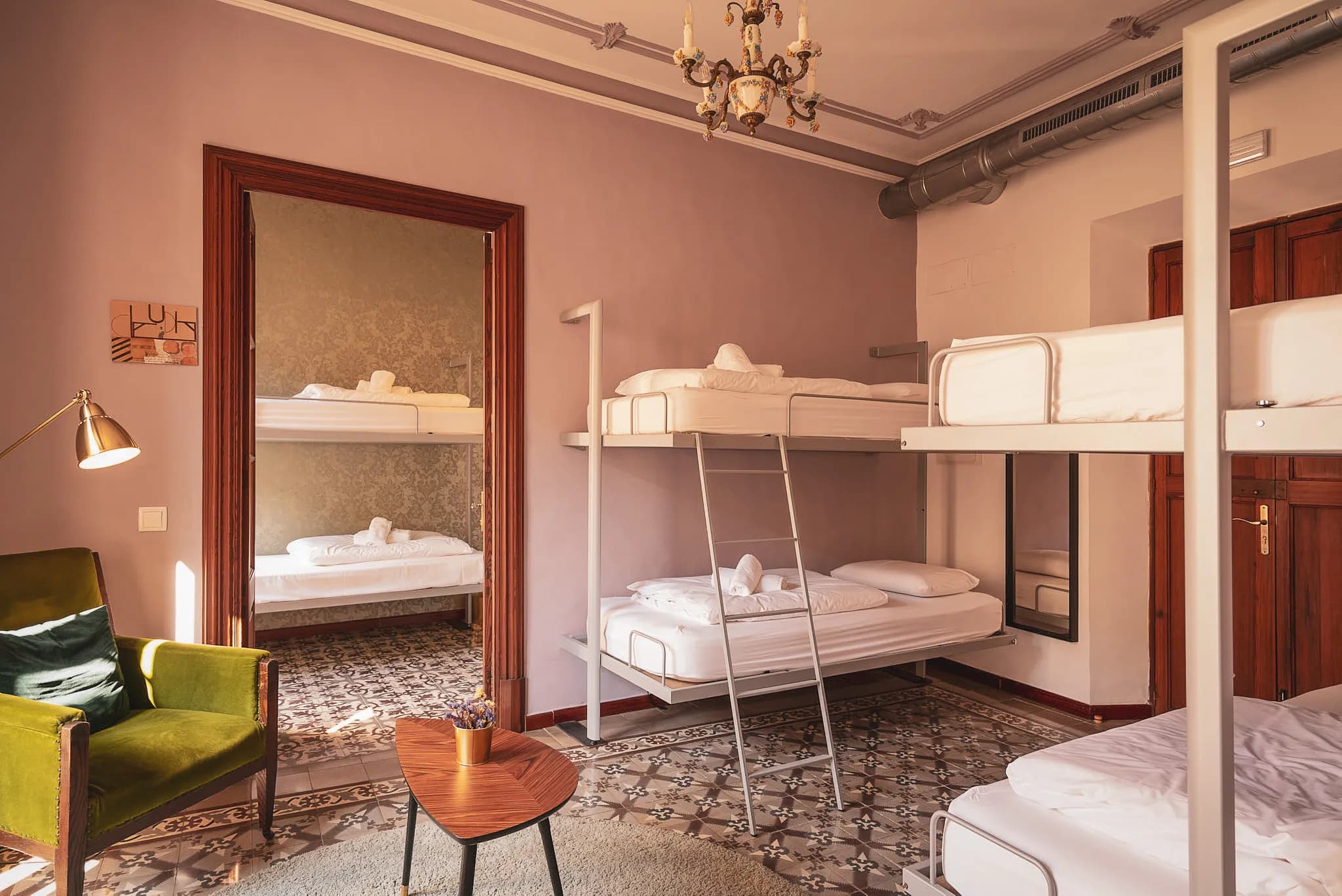 Bright hostel room with bunk beds, cosy decor, ideal for exploring Mallorca.