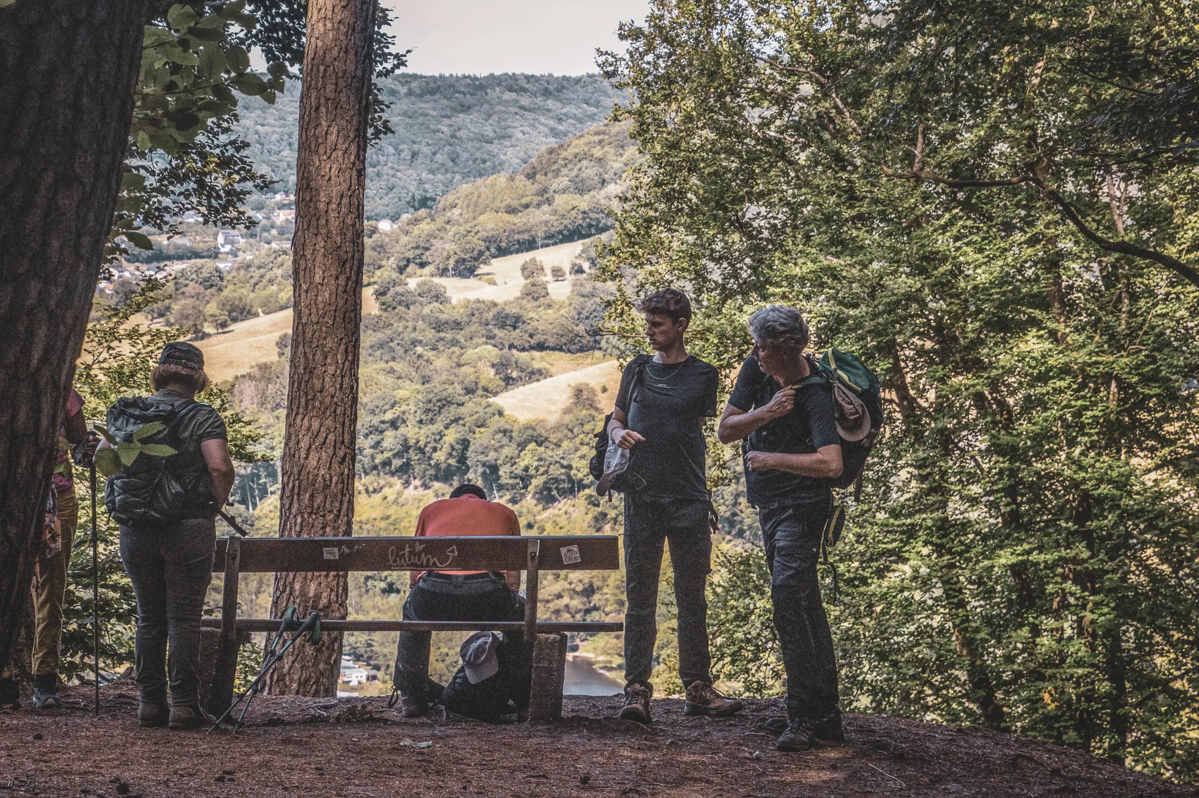 Hikers admiring the panoramic view in Luxembourg's Little Switzerland, an enchanting place.