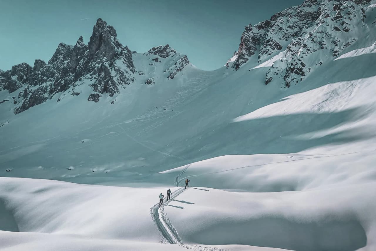 Ski touring explorers through majestic snow-covered landscapes near Mont Blanc.
