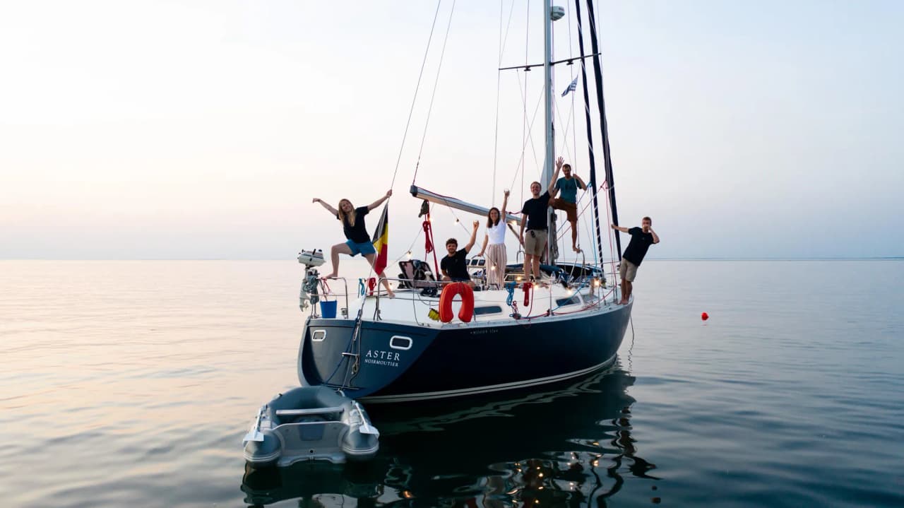 Een gelukkige bemanning op een zeilboot, varend over de kalme wateren van Belle-Île in Bretagne.