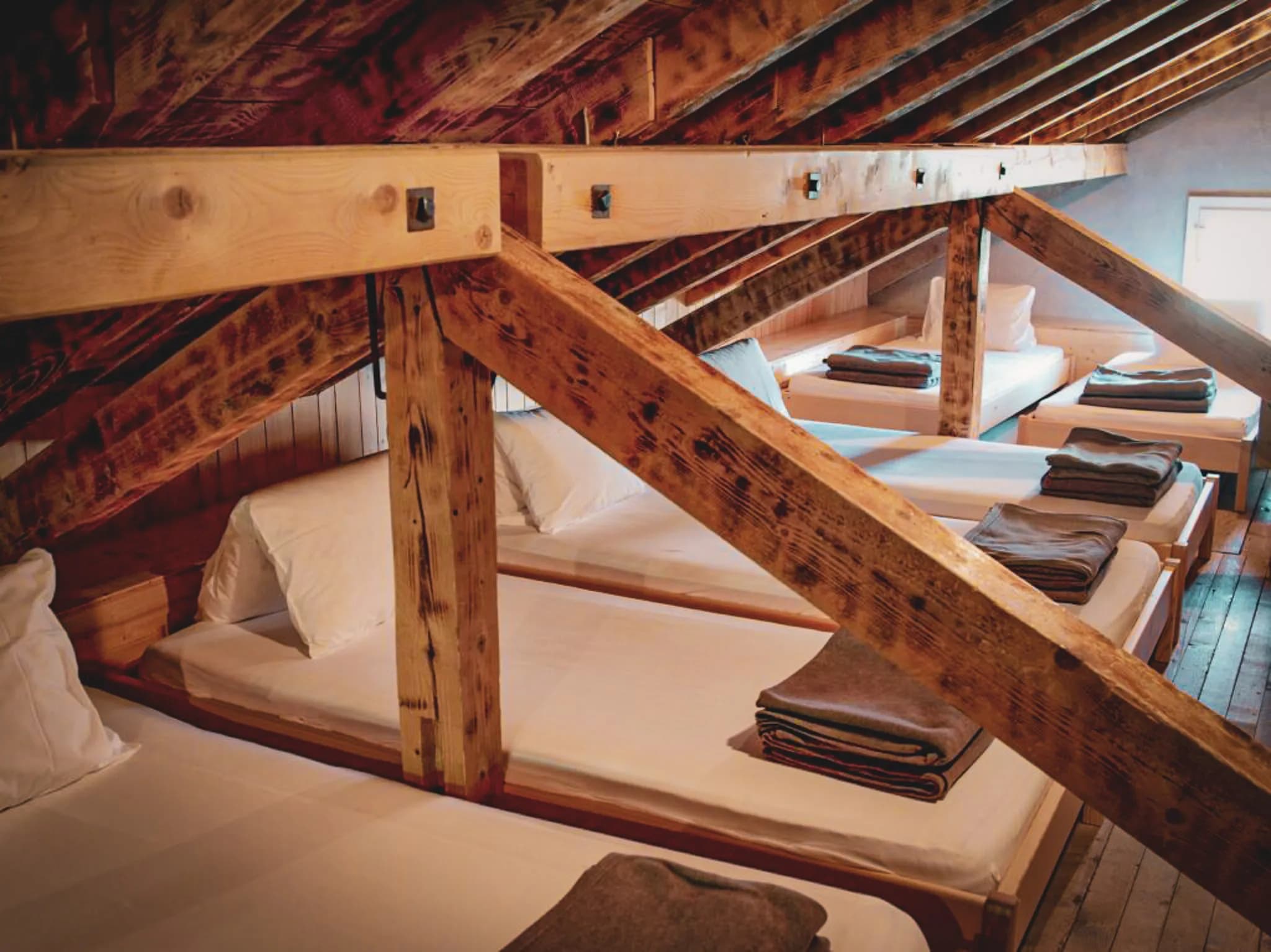 Interior of the Oberaar haus refuge. You can see the bedding with white sheets.