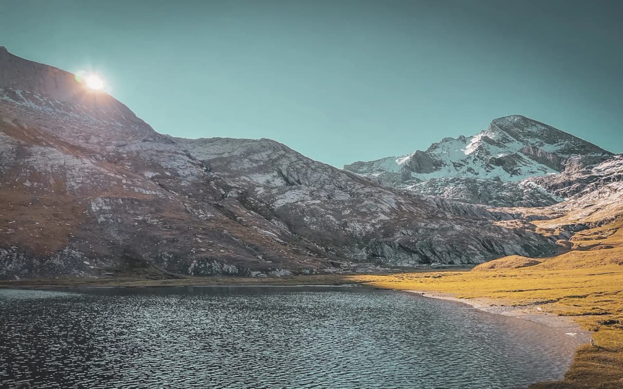 Sparkling lakes surrounded by majestic mountains, illuminated by the setting sun.