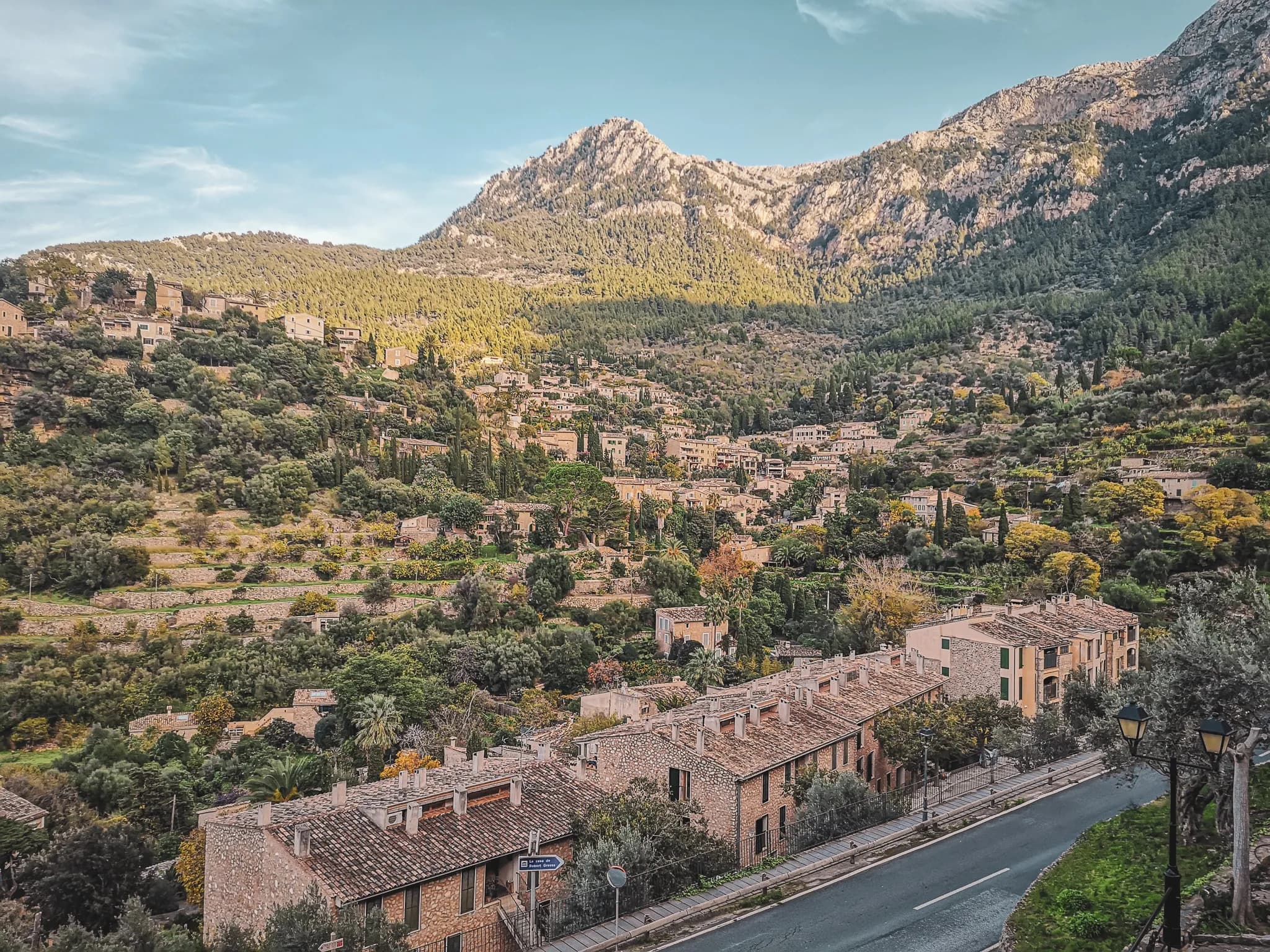 Panoramic views of the picturesque villages of the Serra Tramuntana, surrounded by lush green mountains.