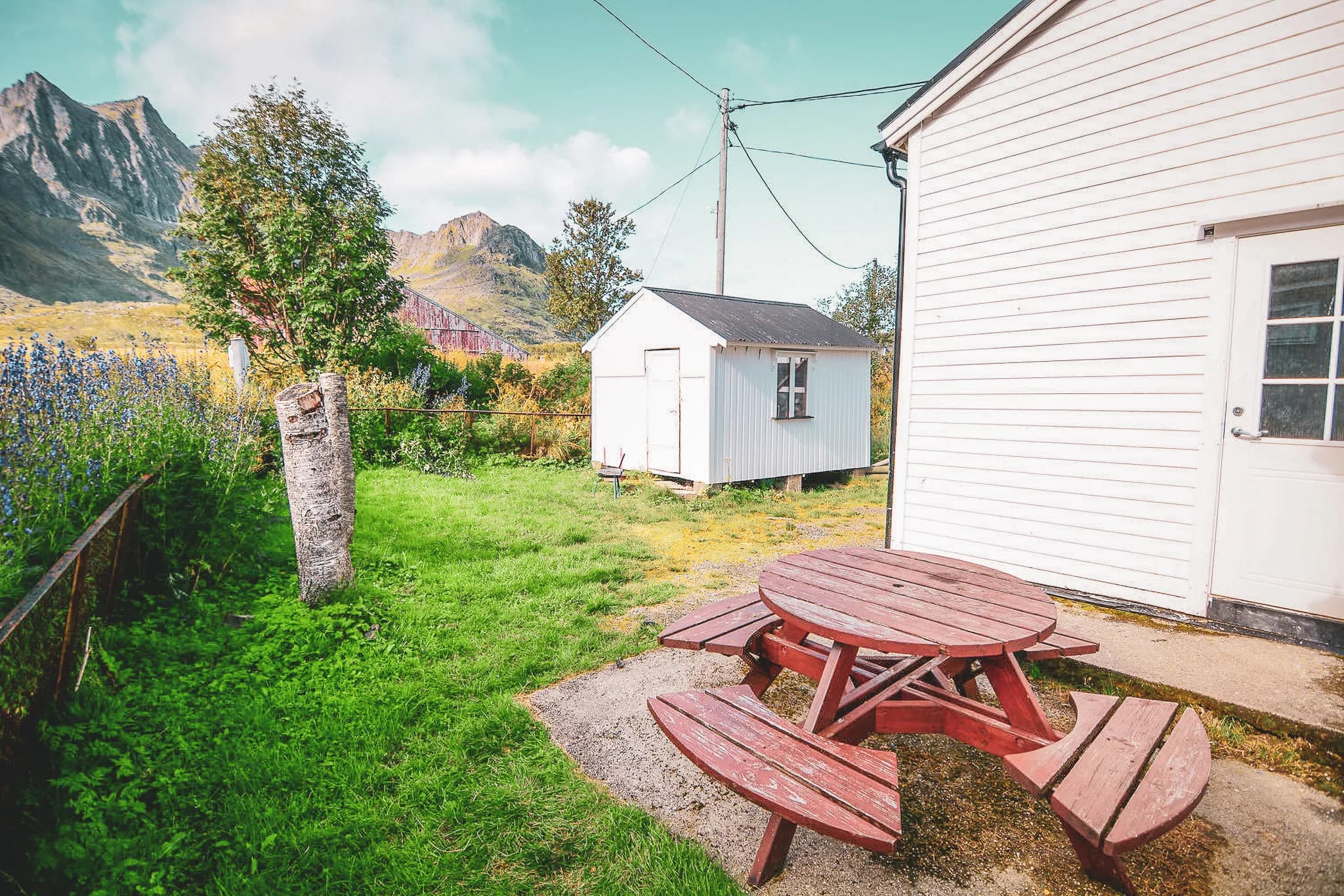 A charming corner of nature in Norway, with a wooden table and majestic mountains in the background.