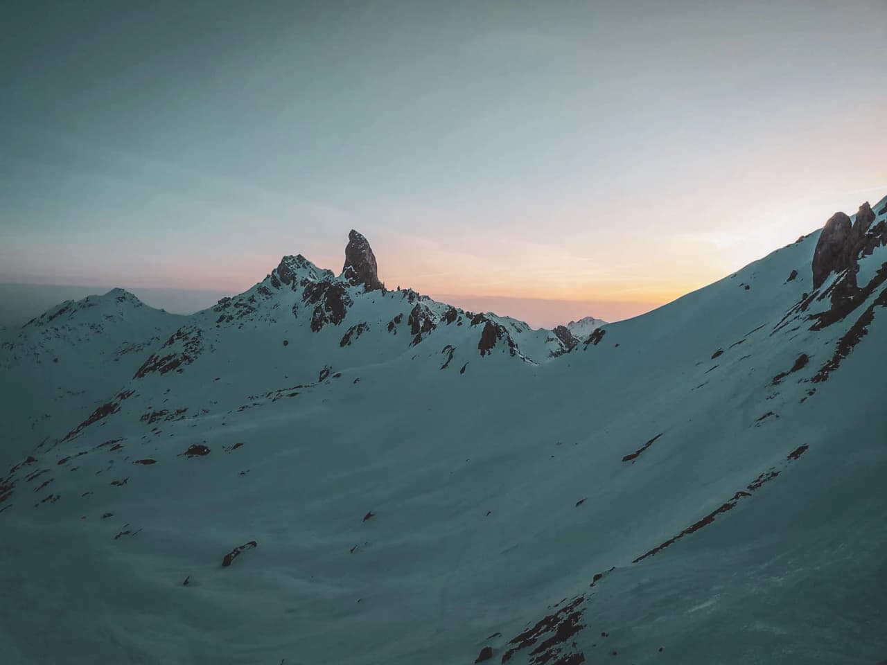 Magnificent alpine scenery under a colourful sky, snow-capped peaks inviting you to adventure.
