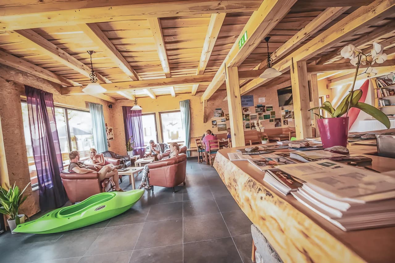 A cosy space with sofas, a green kayak and views of Slovenian rivers.