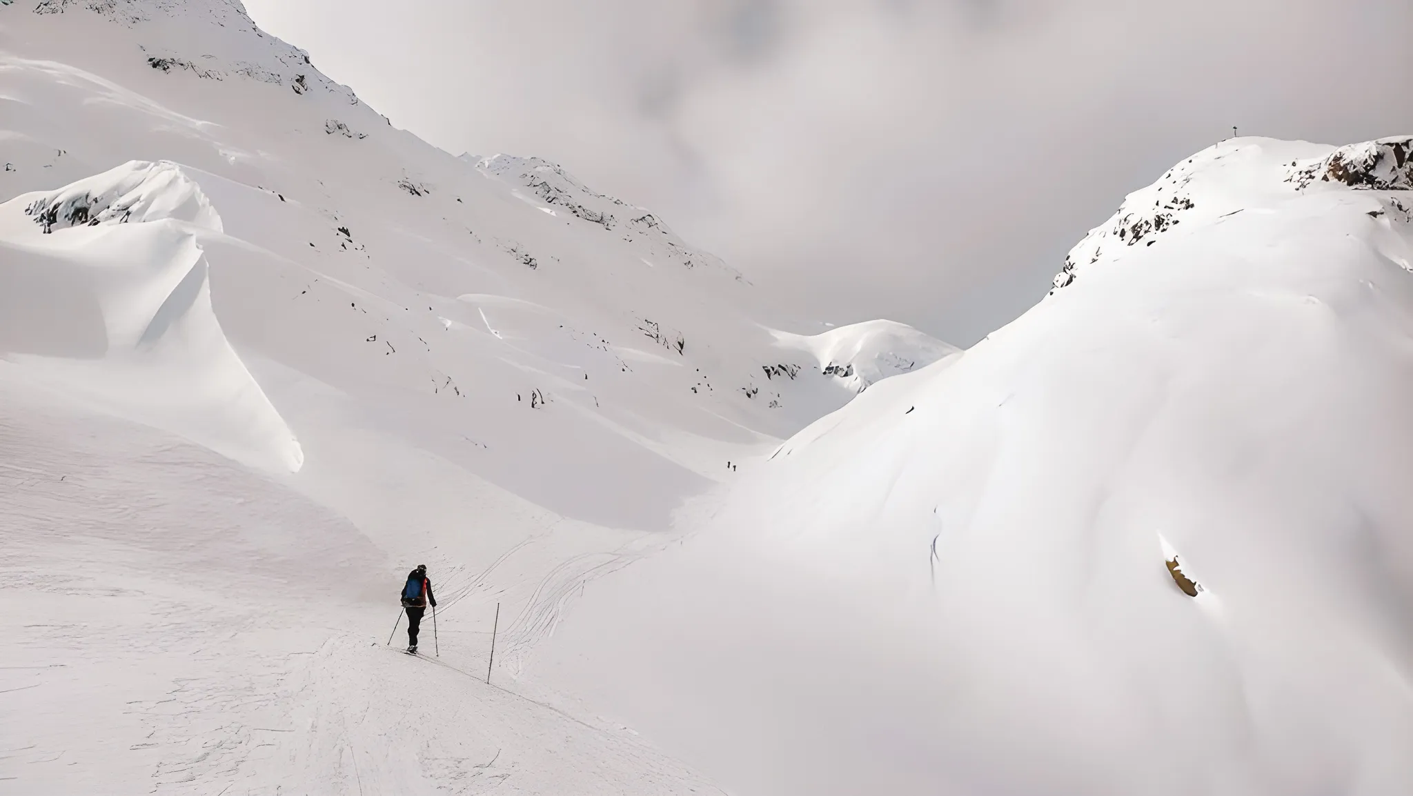 Een eenzame wandelaar in een besneeuwd alpenlandschap, schetst sporen op de smetteloze sneeuw.