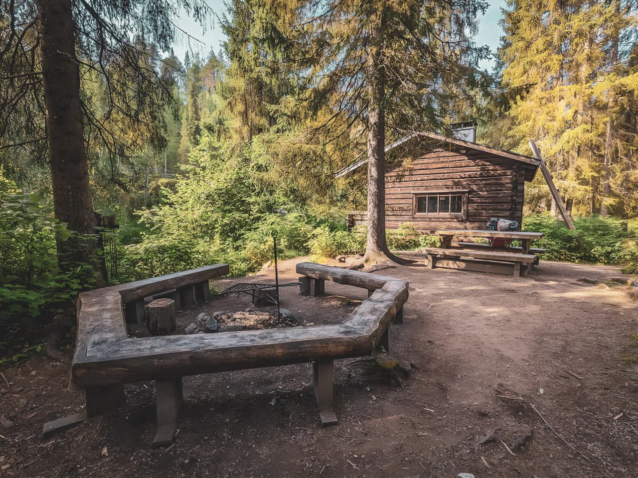 A wooden Mountain hut in the heart of the wilderness, surrounded by trees, ideal for a Lapland adventure.