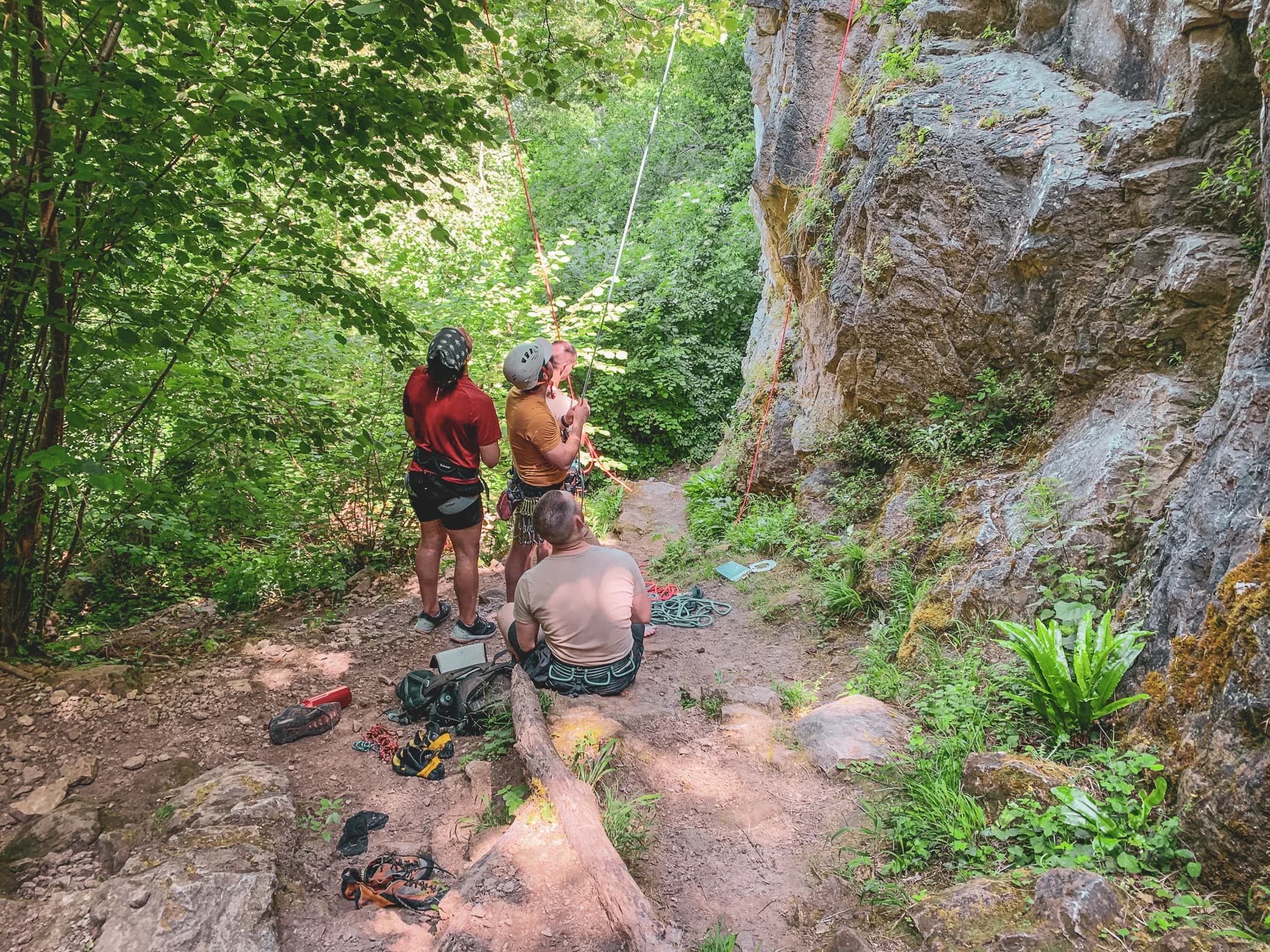 "An introduction to cliff climbing in Belgium, surrounded by lush green countryside and a friendly atmosphere."